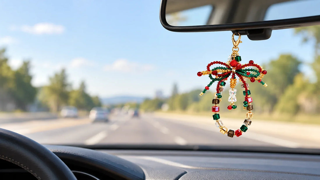 Handmade beaded car charm securely attached beneath a rearview mirror with a clear windshield view
